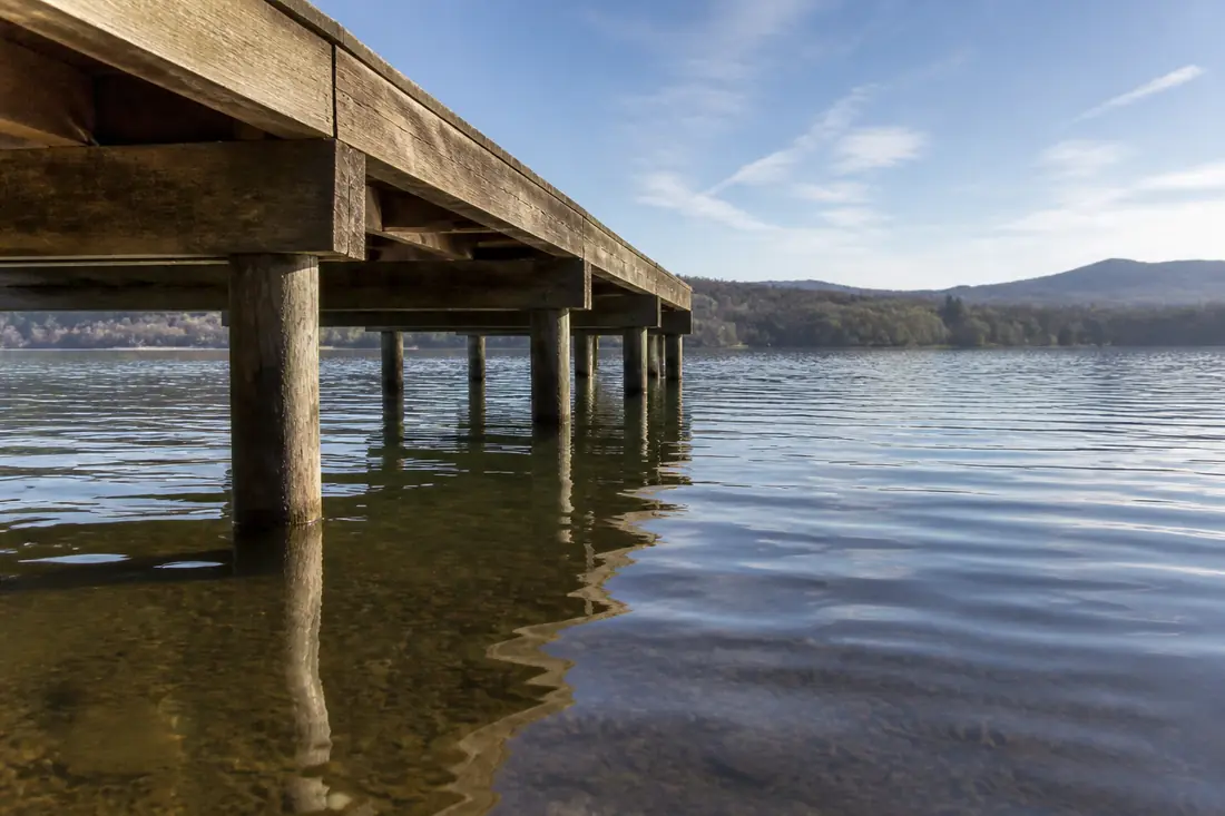 The deck of a fixed pier standing clear above the summer water level