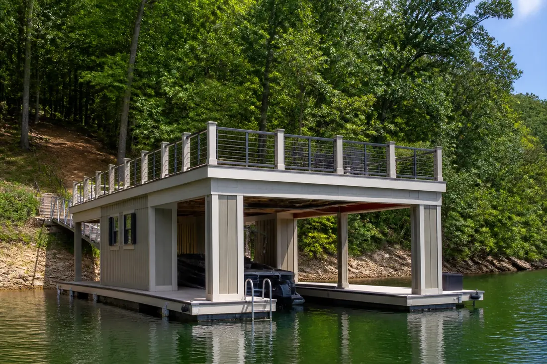 A boathouse with an open railed upper deck and no roof above it