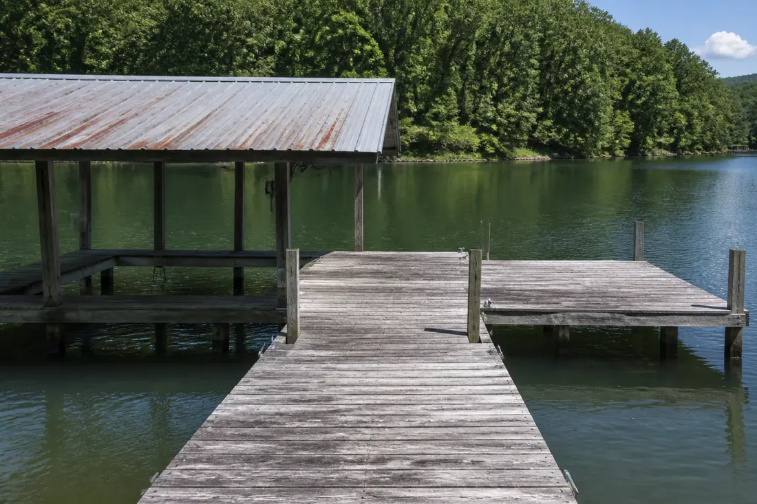 A weathered older dock at a lake property, sound but clearly built some years ago