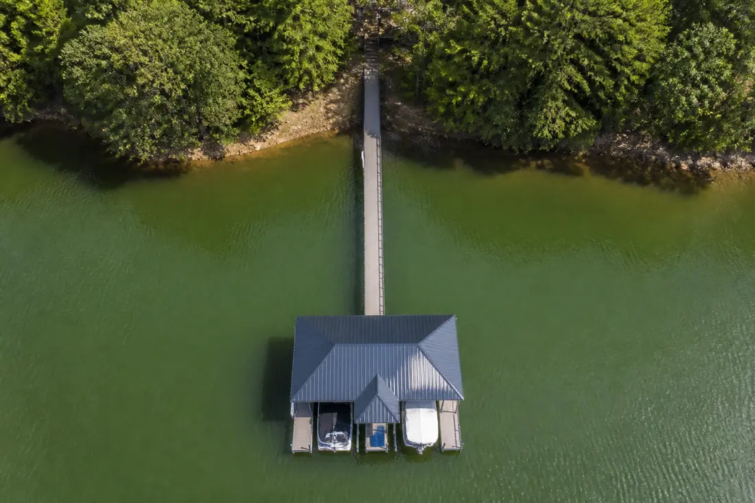Aerial view of a residential dock showing the access walkway running from shore out to a covered dock