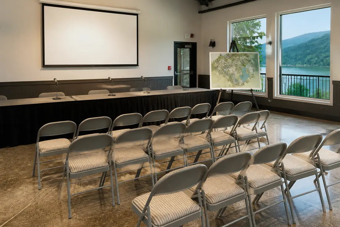 Folding chairs set out in a public meeting room before a hearing